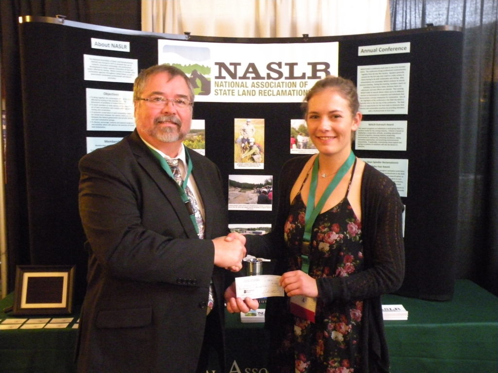 Picture of Sam Faith presenting Scholarship Winner Florence Miller a check from NASLR.