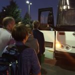 Picture of attendees boarding buses.